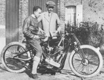 Michael McEvoy sits on his 1924 8-valve Anzani powered bike. Claude Temple looks on.